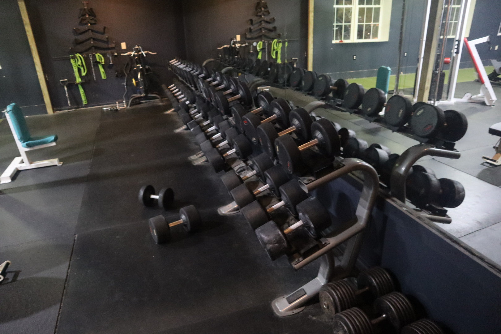 Long dumbbell rack and lifting benches at Mifflinburg Muscle & Fitness