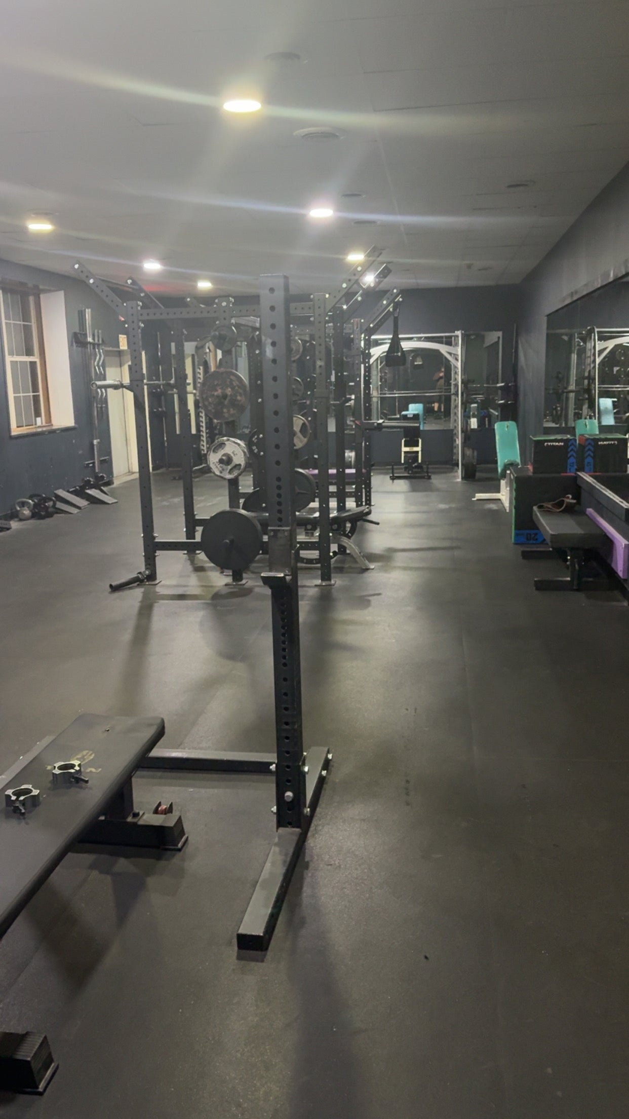 Power racks and loaded barbells on the Mifflinburg Muscle & Fitness gym floor